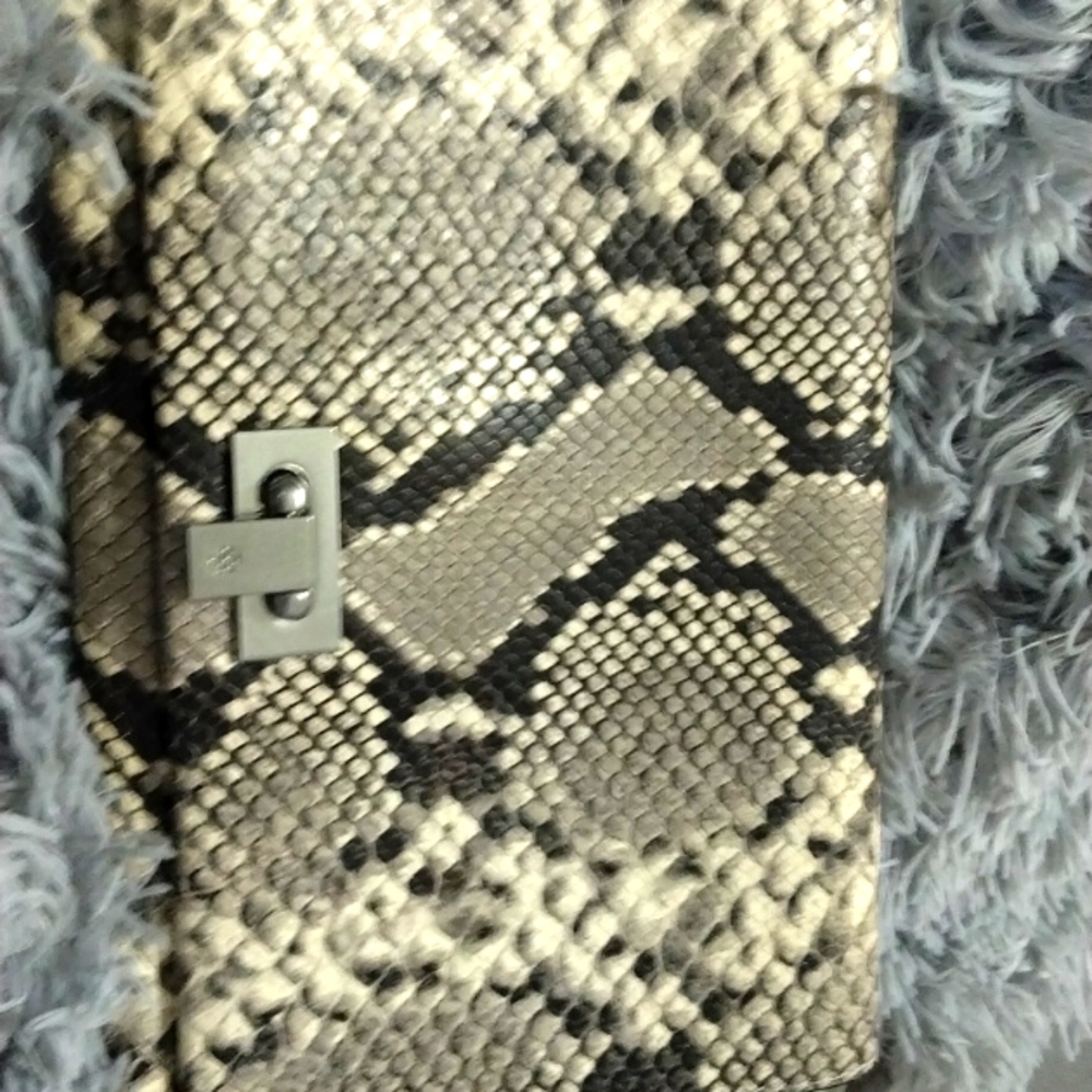 Tony Burch snake skin clutch it is a Tony Burch real snakeskin perfect condition